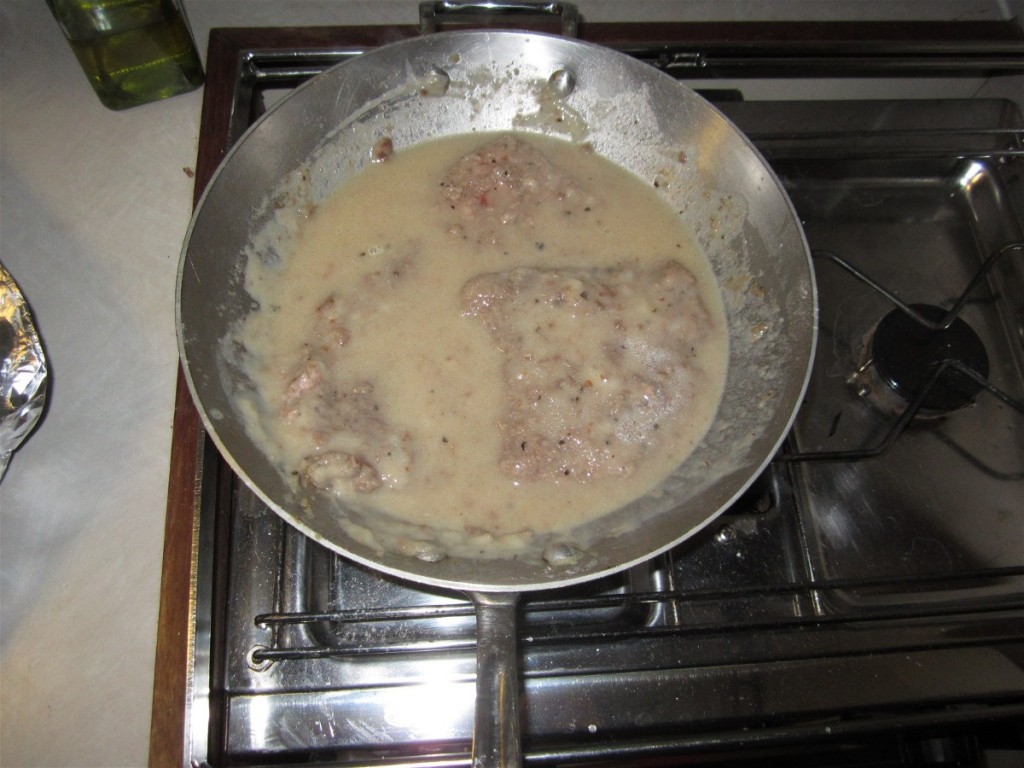 remove the meat; add milk, or butter; scrape the pan and add more flour and oil; then the cooked meat; add water; and simmer for a while