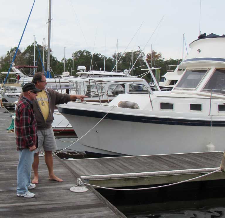 Bob, on right, instructs boat neighbor on departure assistance